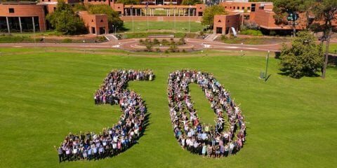 staff forming shape of a 50 for 50th anniversary
